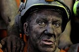 Picture of a miner with hard hat on.