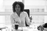 Woman talking to team at table