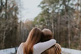 Two friends with arms around each other