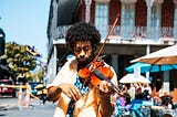 Man plays violin on street corner