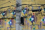 Wall mural with stylized faces with single eyes watching