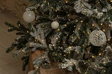Close up of a Christmas tree with matching white bulb decorations.
