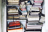 Piles of saved journal on a closet shelves