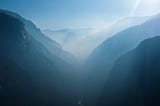 Yosemite valley. There is some mist and the mountains are a blueish hue.