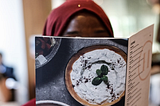 Woman reading a restaurant menu. From Stock Photos.