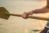 Close-up of a hand gripping an oar, symbolizing taking control of your life and actively steering toward your goals.