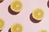 Stylized picture of lemons against a pink background