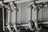 grayscale photography of metal pipes