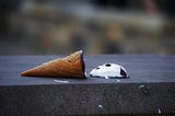 Ice cream cone melts where someone accidentally dropped it