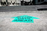 A message painted on the ground that says, “BETTER DAYS AHEAD”