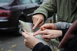 Drivers consulting a paper map