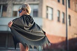A child in a mask and cape, looking to become a superhero with his own superpowers.