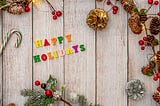 Happy holidays lettering on a plank board
