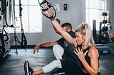 Woman doing one arm pulldowns.