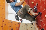 A man rock climbing to the top.