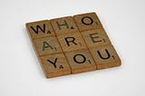 “Who are you,” spelled out with Scrabble tiles.