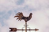 Antique weathervane with a cloudy background