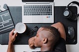 An exhausted man lying on the work table