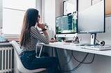 Front end developer coding in front of their computer with two monitors