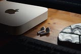 Mac mini next to some air pods