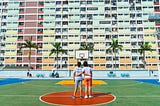 Collaborators standing in front of a colorful building