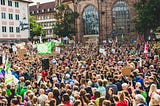 A large crowd of protesters in daylight.