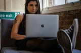 Woman working with a MacBook Pro at a tech company