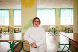 A woman sits at a table.