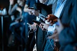 An image of students holding mobile phones