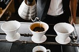 Servant preparing a pour-over coffee