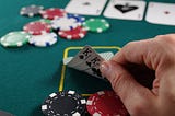 Man playing poker showing his cards