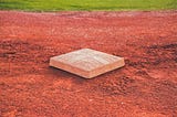Open base on infield dirt of a baseball field