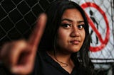 Woman holds up a hand in a “stop” gesture