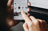 A person is holding a smartphone and browsing the SumUp Instagram profile.