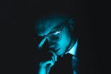 The writer pictures a man sitting with his eyes closed, in thought.