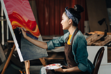 Woman picking up creative hobby for stress relief: painting