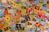 Photograph of many Pokemon Cards on a Table