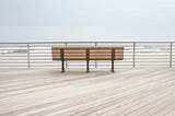 A wooden bench on the boardwalk.