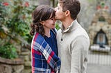 Here is a couple gently embracing each other, and the gentleman softly plants a kiss on her forehead, representing an apology after a silly argument.