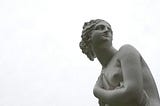 Back and white classic statue of a woman’s head and torso, looking over her shoulder.