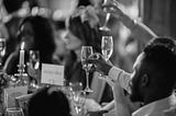 Guests at the reception lifting glasses in a toast