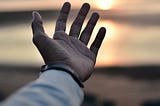 A hand and a sunset