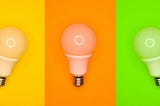 Three colored columns with light bulbs. Yellow, orange, and green.
