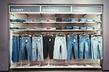 A variety of many hanging and folded jeans