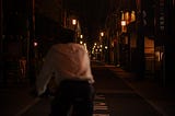 A dimly lit Kyoto street lined with traditional bars and restaurants