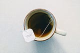 A mug of tea with a tag that says “Kindness is the gift of life”