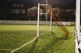 An empty football goal on a school field