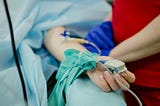 person’s arm with monitors in hospital