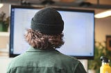 A man in front of a computer.