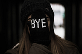 A photo of a woman with a gloved hand covering her face